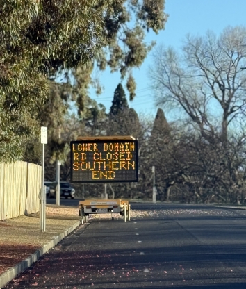 An image of Lower Domain Road with a sign listing an upcoming road closure