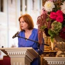 Her Excellency speaking at a lectern.