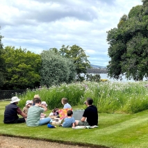 People eating lunch on the lawns at Government House